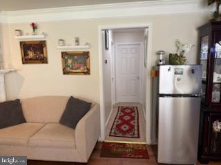 46891 Eaton Terrace, Unit 101 Sterling, VA 20164 - Photo 38 of 41 a living room with furniture and a refrigerator