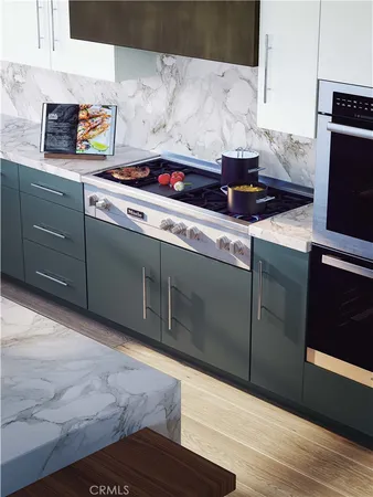 a kitchen with stainless steel appliances granite countertop a sink stove and cabinets