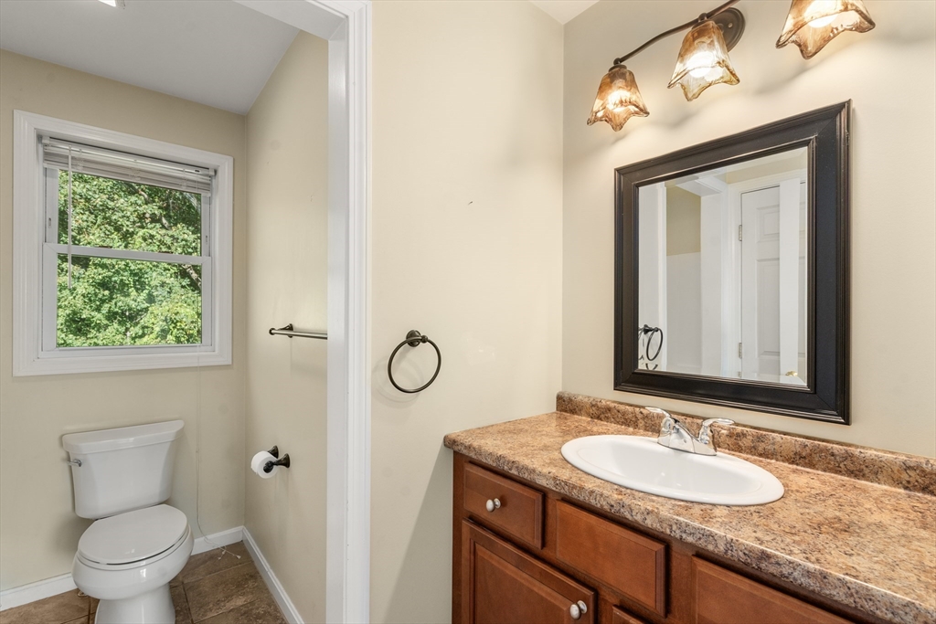 190 Old Road Dracut, MA 01826 - Photo 16 of 36 a bathroom with a granite countertop sink a toilet and a mirror