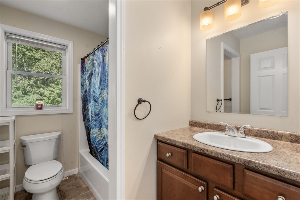 190 Old Road Dracut, MA 01826 - Photo 21 of 36 a bathroom with a granite countertop sink toilet and a mirror