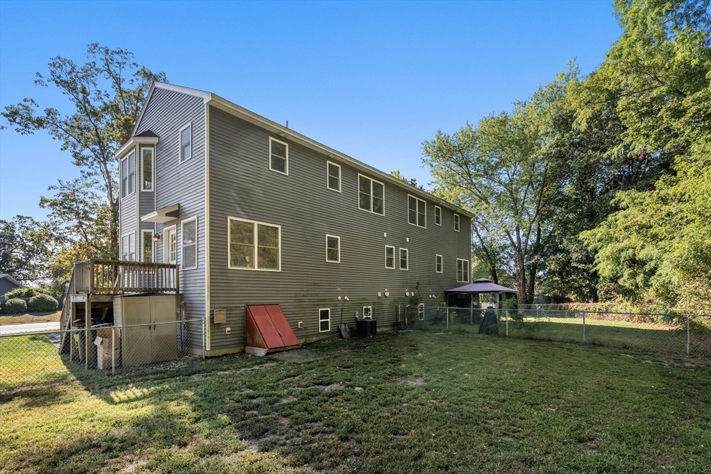 190 Old Road Dracut, MA 01826 - Photo 27 of 36 a backyard of a house with table and chairs