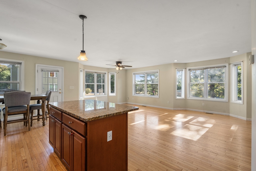 190 Old Road Dracut, MA 01826 - Photo 4 of 36 a kitchen with granite countertop a sink stove and wooden floor
