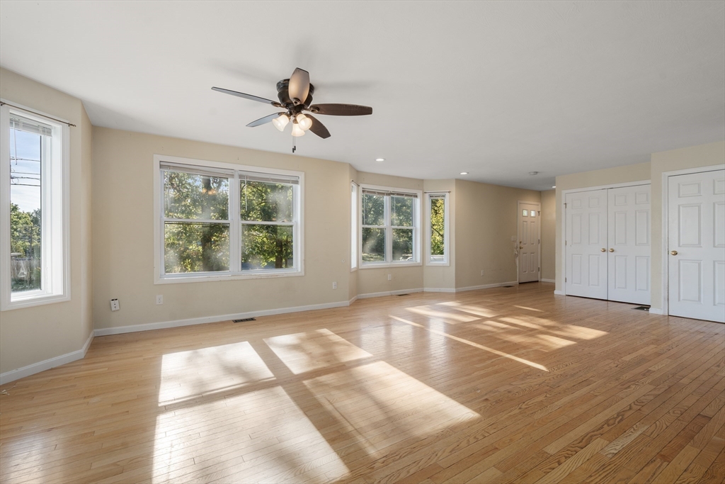 190 Old Road Dracut, MA 01826 - Photo 9 of 36 a view of an empty room with wooden floor and a window