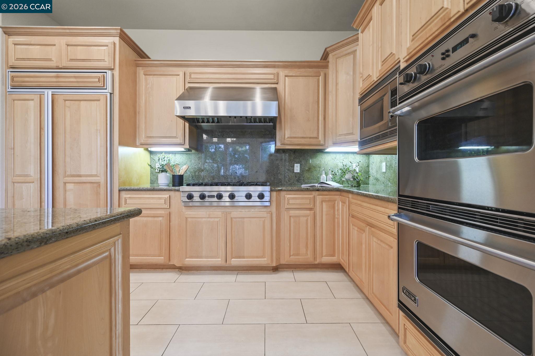 135 Diablo Ranch Court Danville, CA 94506 - Photo 22 of 60 a kitchen with stainless steel appliances granite countertop a stove and a microwave