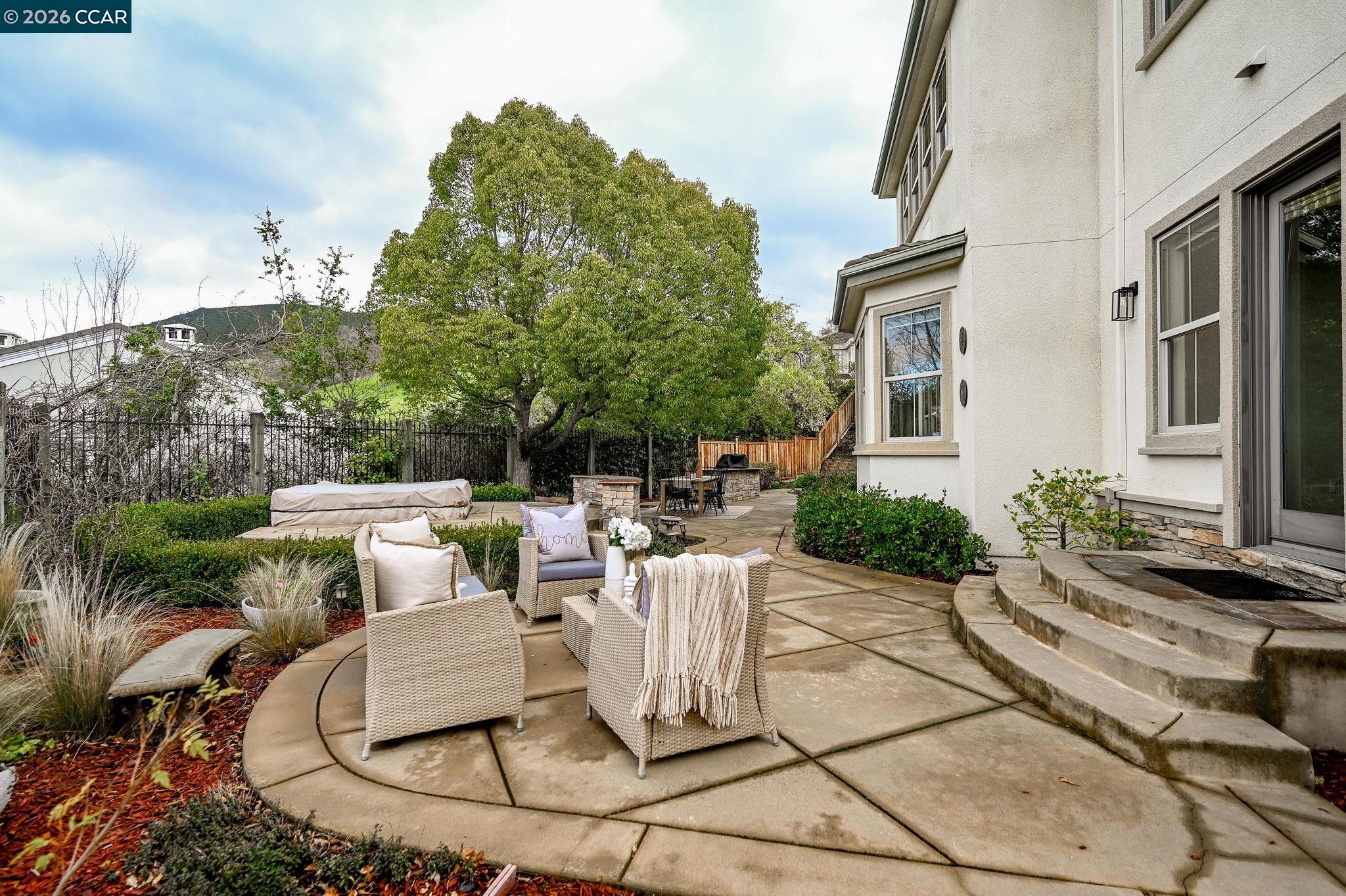 135 Diablo Ranch Court Danville, CA 94506 - Photo 44 of 60 a view of a patio with table and chairs potted plants and large tree