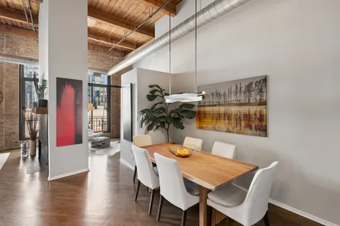 a view of a dining room with furniture and wooden floor