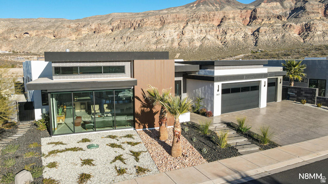 3607 South Cypress Pt Road Hurricane, UT 84737 - Photo 6 of 59 Contemporary house with driveway, a mountain view, and a garage.
