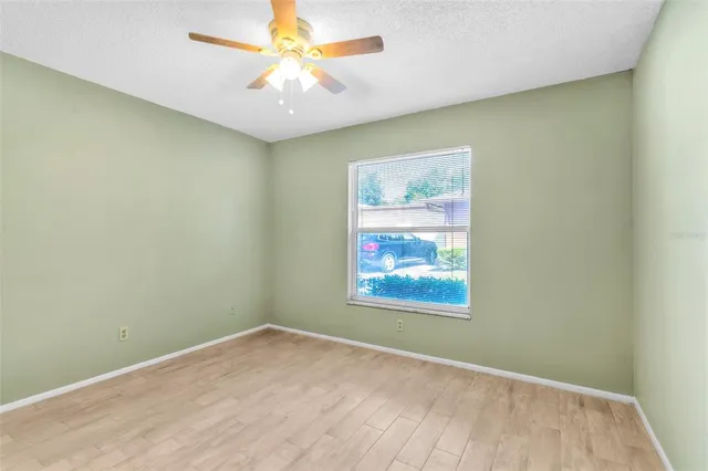 an empty room with a ceiling fan