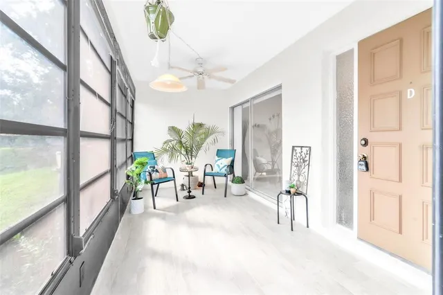 a view of a dining room with furniture a chandelier and a large window