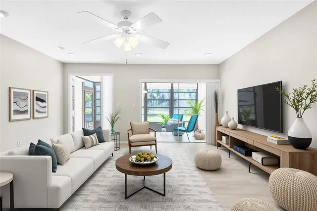 a living room with furniture a rug and a flat screen tv