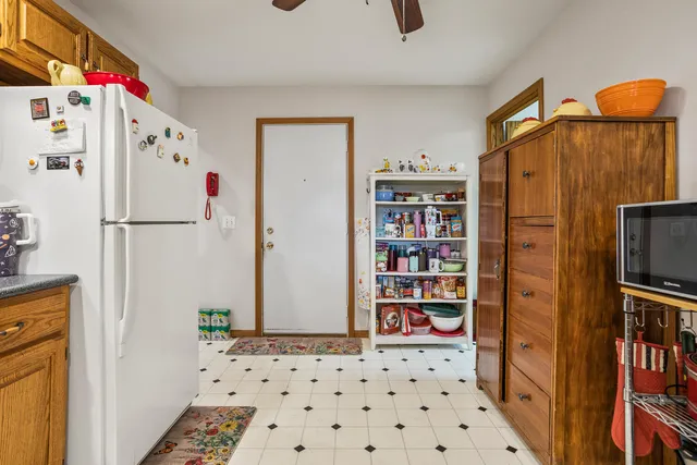 a white refrigerator freezer sitting inside of a kitchen