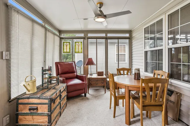 a dining room with furniture and window