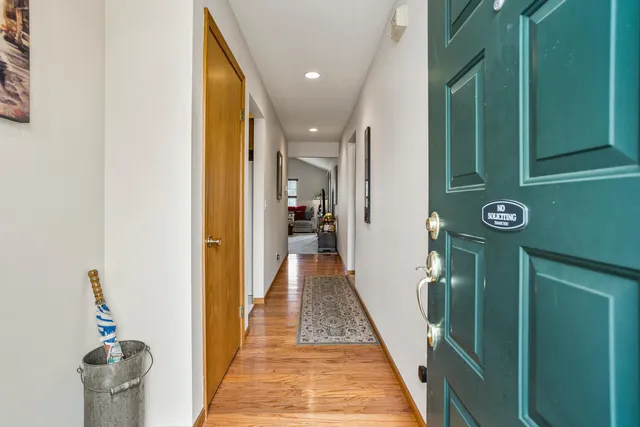 a view of hallway with wooden floor