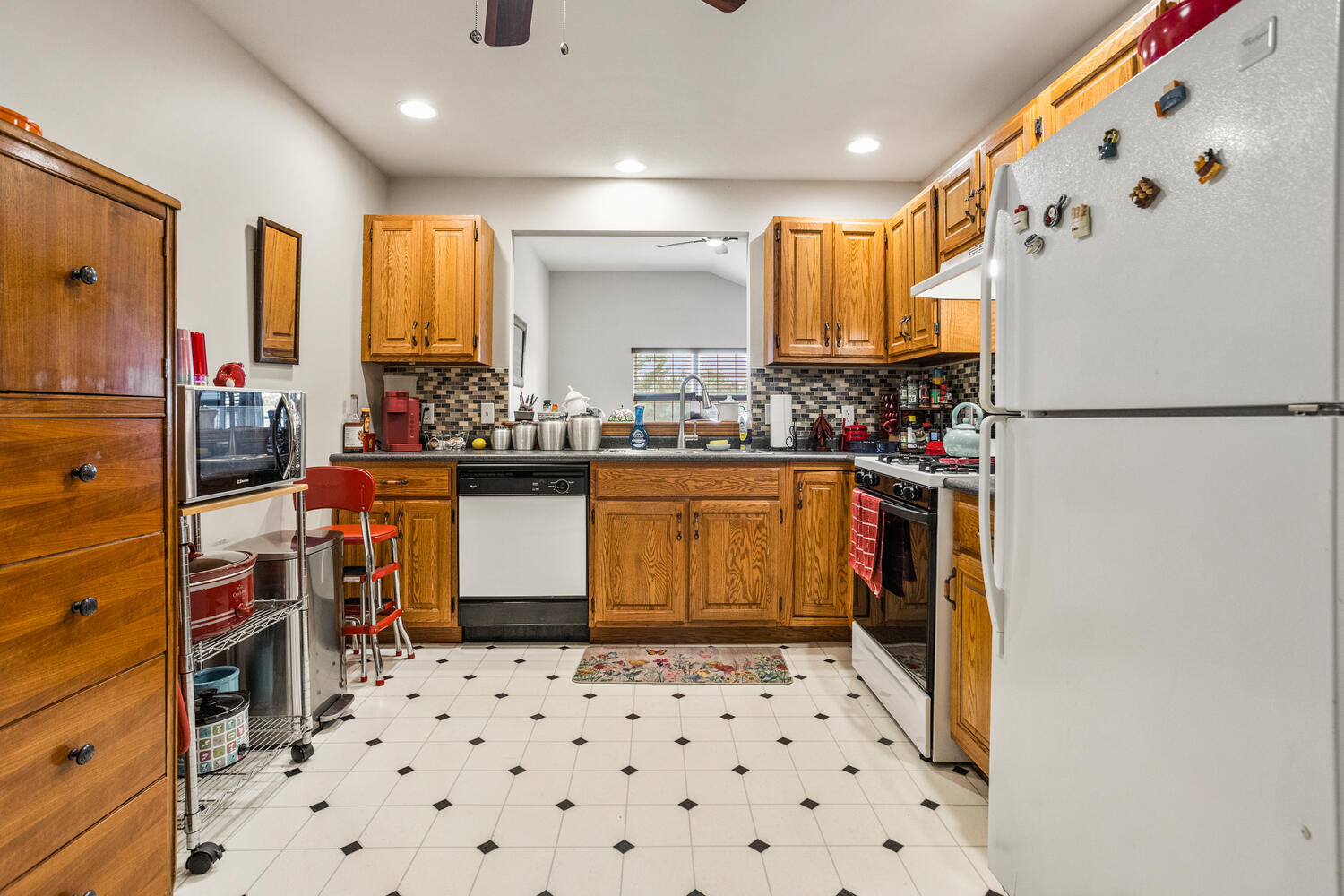 709 Erin Drive Champaign, IL 61822 - Photo 10 of 30 a kitchen with a sink a refrigerator and cabinets