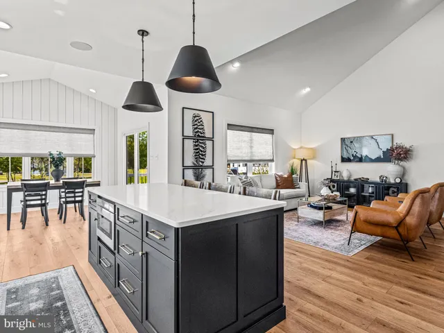 a kitchen with stainless steel appliances granite countertop a stove and a wooden floors