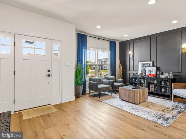 a living room with furniture window and wooden floor