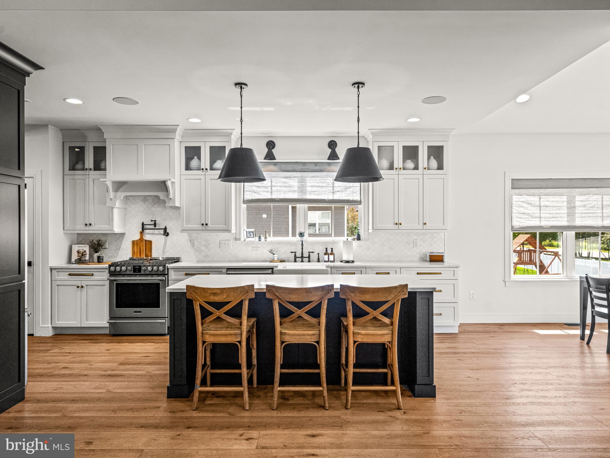3455 C Durham Road Doylestown, PA 18902 - Photo 10 of 21 a kitchen with stainless steel appliances granite countertop a stove top oven a sink dishwasher and white cabinets with wooden floor