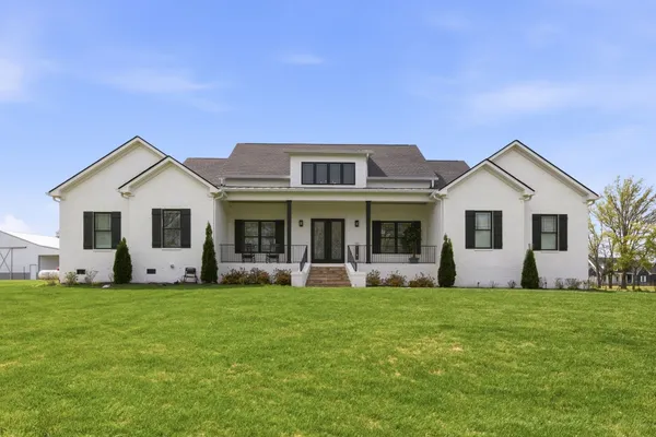 a front view of house with yard and and trees