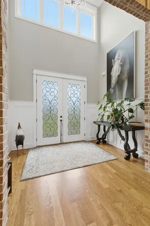 a living room with couch potted plant and a window
