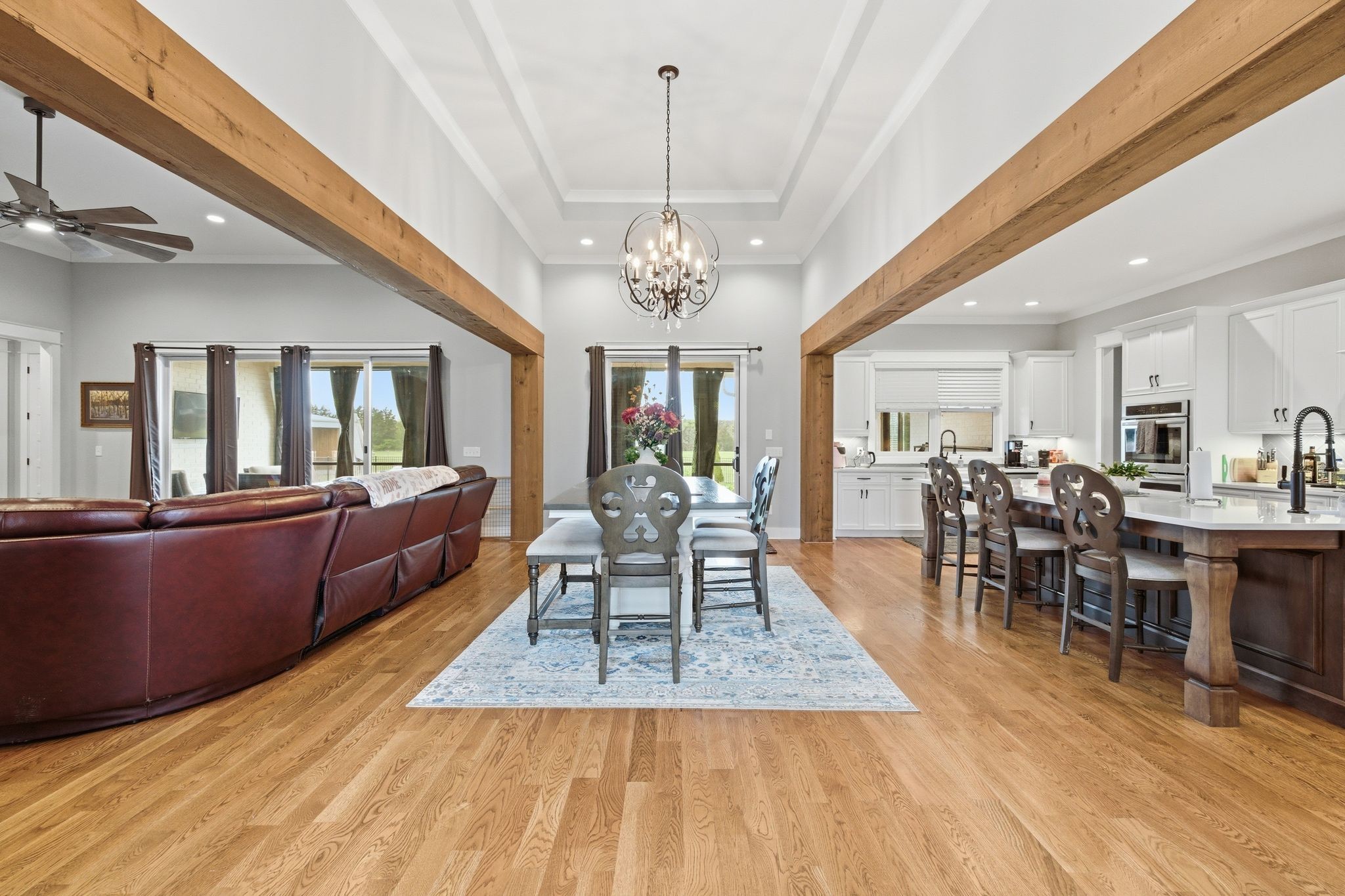 8516 Lowe Christiana Road Christiana, TN 37037 - Photo 13 of 53 a dining room with wooden floor a chandelier a wooden table and chairs