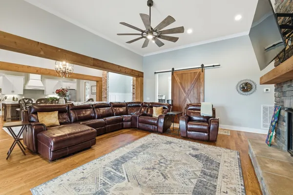 a living room with furniture ceiling fan and a rug