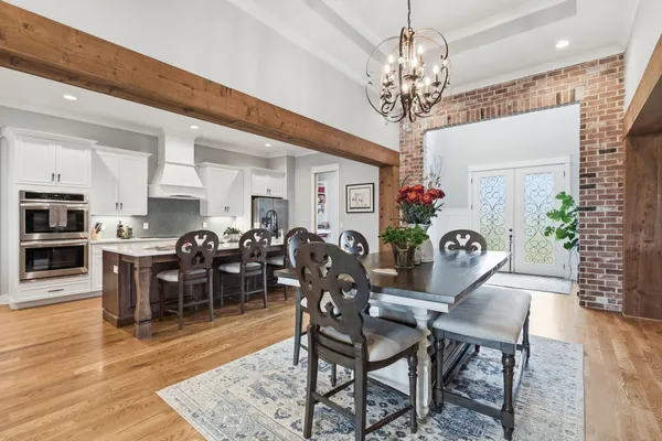 a view of a dining room with furniture and chandelier