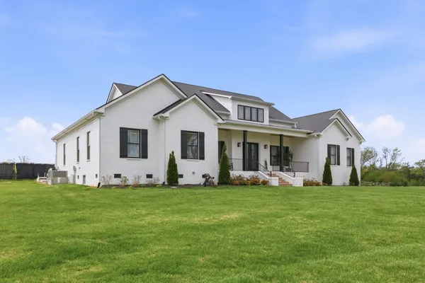 a front view of house with yard and green space
