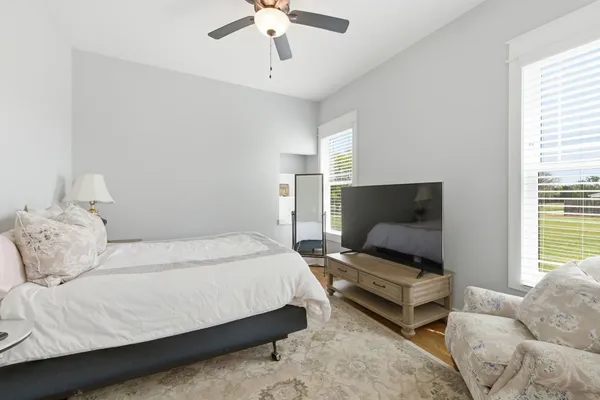 a spacious bedroom with a bed and a couch