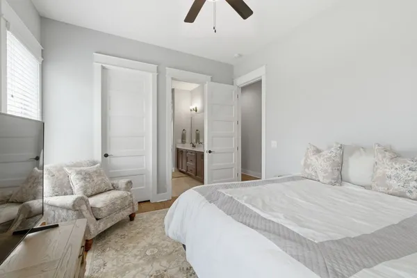 a bedroom with furniture and a window