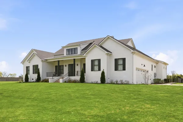 a front view of house with yard and green space