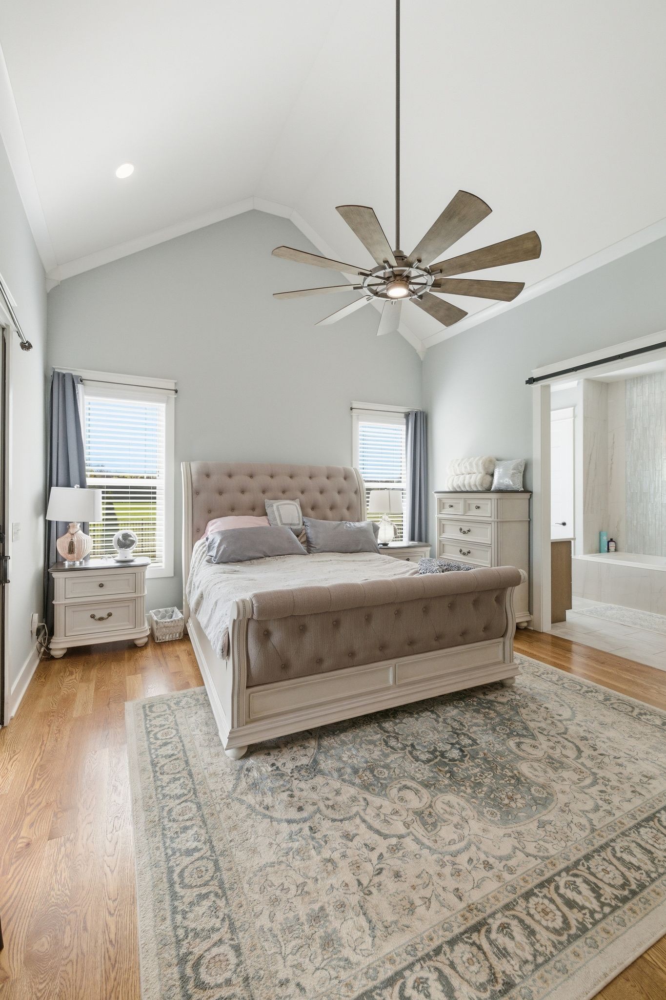 8516 Lowe Christiana Road Christiana, TN 37037 - Photo 35 of 53 a bedroom with a large bed and a ceiling fan