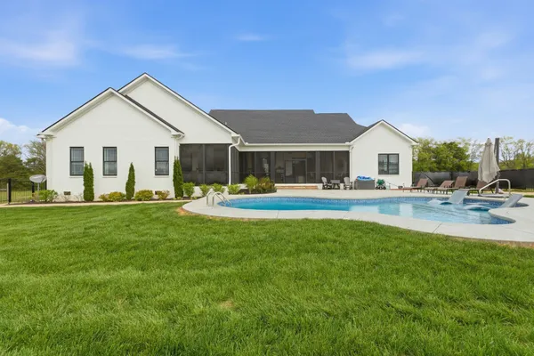 a view of outdoor space with swimming pool and seating