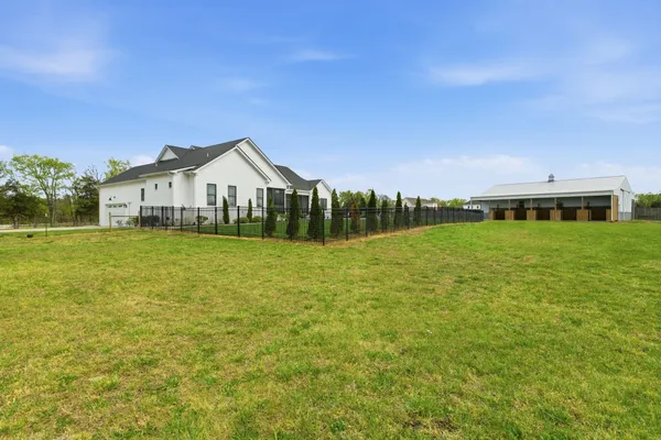 a backyard of a house with lots of green space and plants