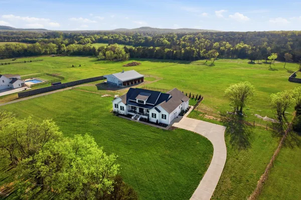 an aerial view of a house with big yard
