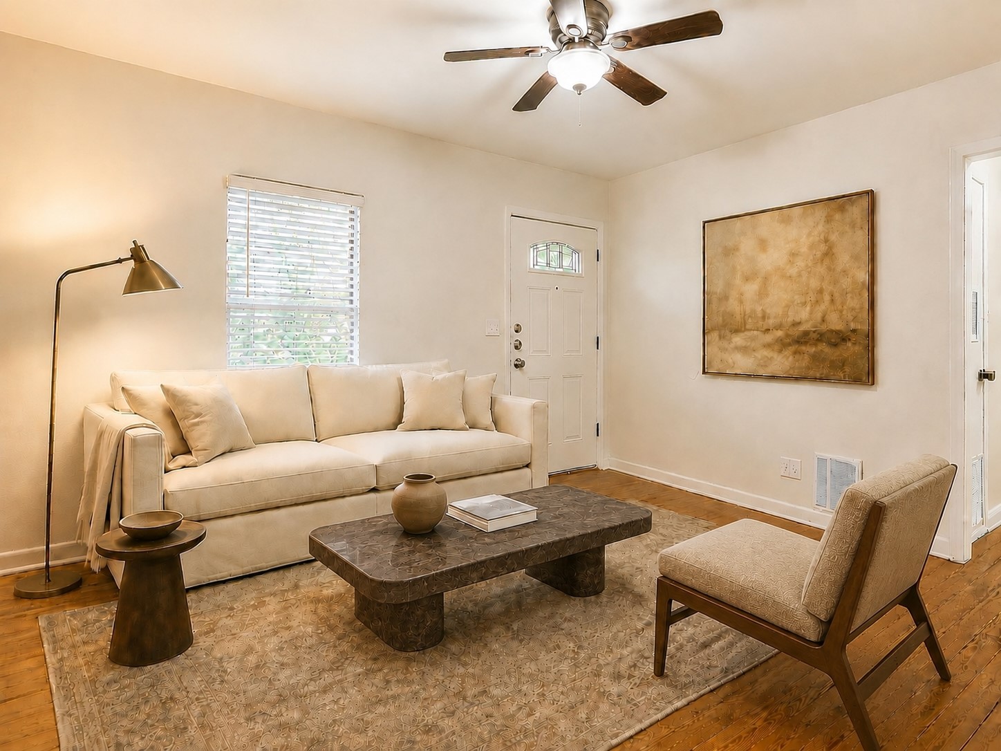Rich hardwood flooring complements the simple lines of this inviting entrance space. Digitally styled.