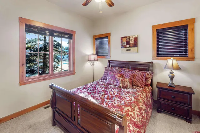 a bed sitting in a bedroom next to a window