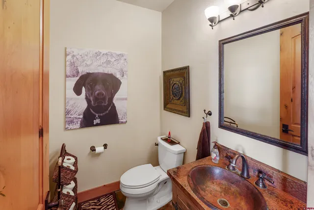 a bathroom with a toilet a sink and a mirror
