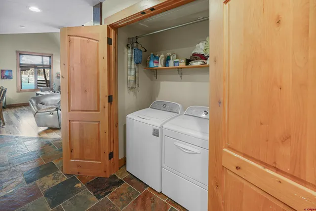 a view of storage and utility room with washer and dryer