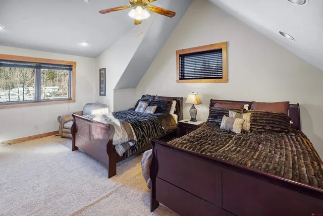 a bedroom with two beds and a chandelier