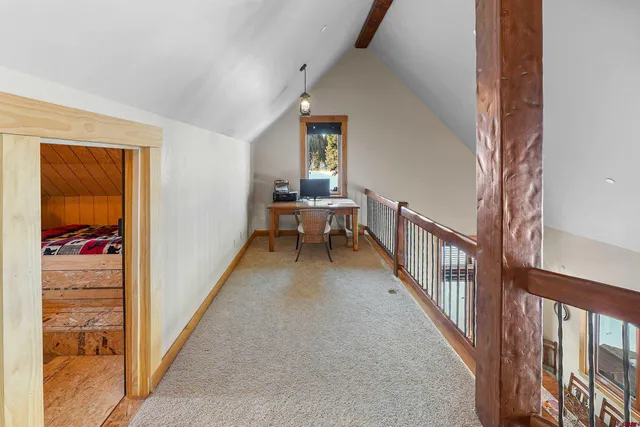 a view of a hallway with a white walls and stairs