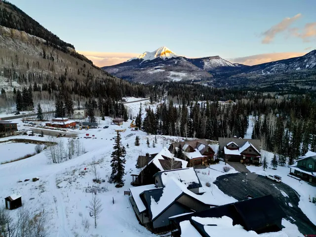 a view of backyard with seating space and a barbeque