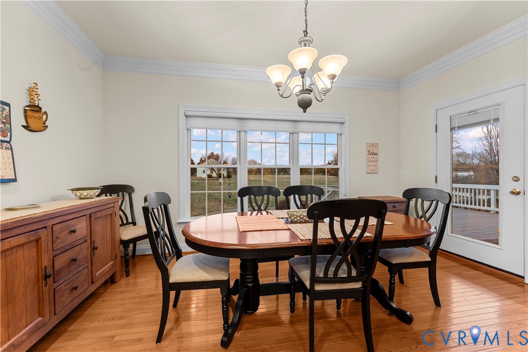 270 Petersburg Road Powhatan, VA 23139 - Photo 21 of 90 a view of a dining room with furniture a chandelier and wooden floor