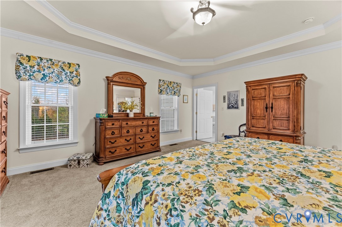 270 Petersburg Road Powhatan, VA 23139 - Photo 33 of 90 a bedroom with a bed and dresser with mirror