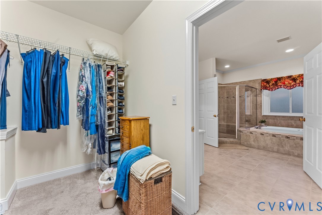 270 Petersburg Road Powhatan, VA 23139 - Photo 40 of 90 a view of walk in closet with clothes and shoes