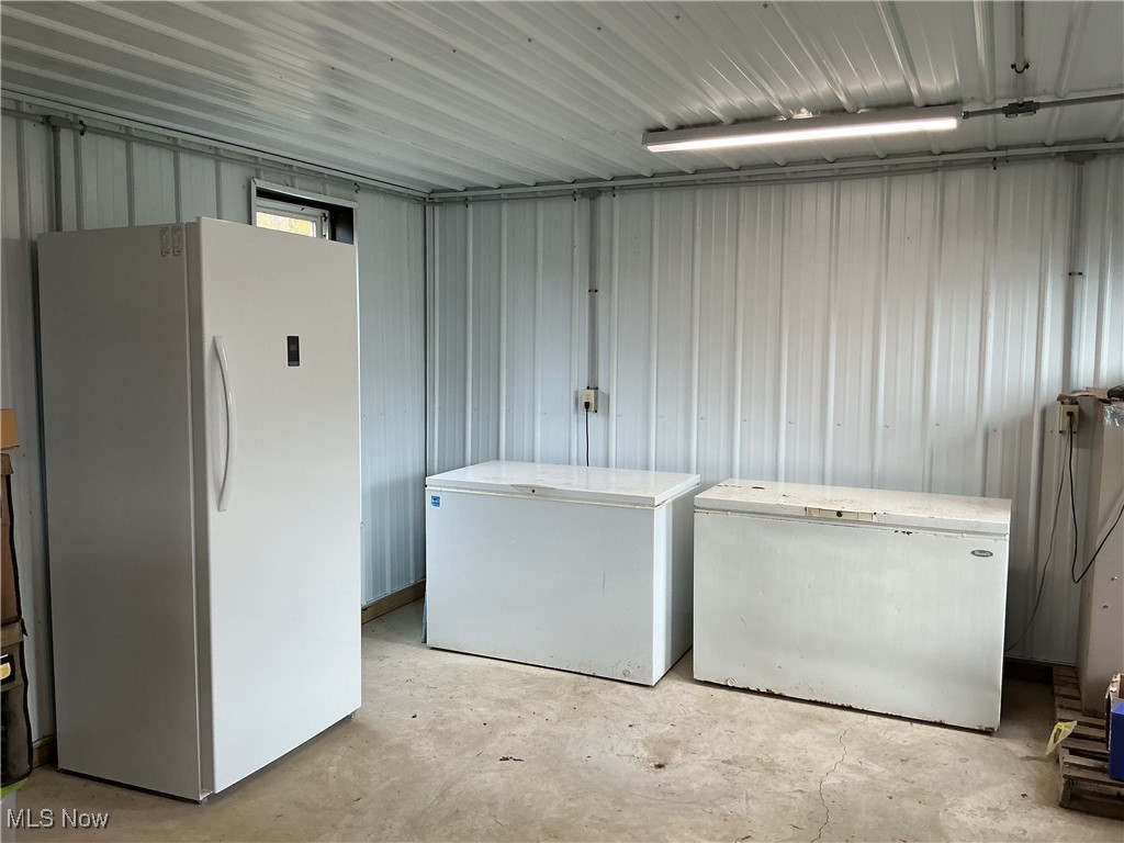 10550 Symmes Creek Road Adamsville, OH 43802 - Photo 19 of 21 Laundry area with unfinished concrete floors and metal wall