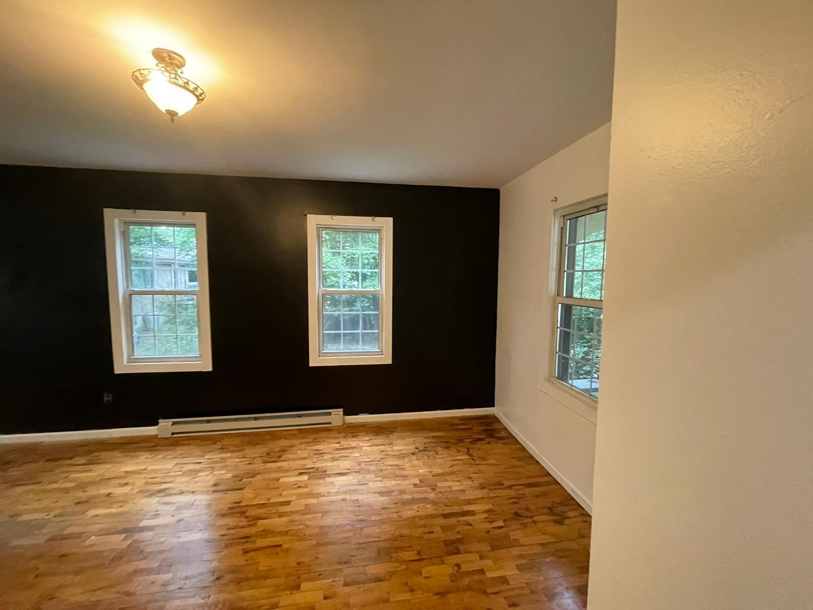 4710 State Rte 55 Bethel, NY 12783 - Photo 8 of 30 Spare room featuring hardwood / wood-style floors, a wealth of natural light, and a baseboard radiator