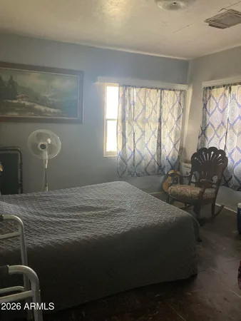 a bedroom with a bed and window
