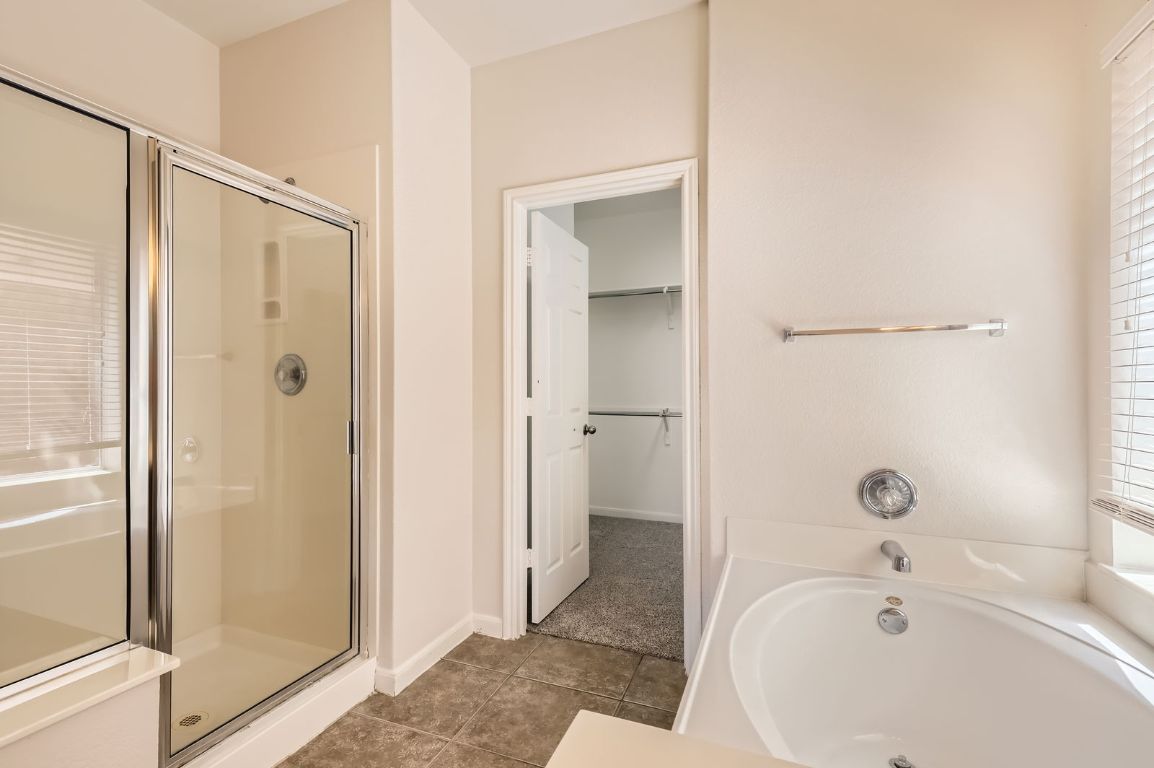 3423 Shiraz Loop Round Rock, TX 78665 - Photo 14 of 28 a bathroom with a bathtub and a shower