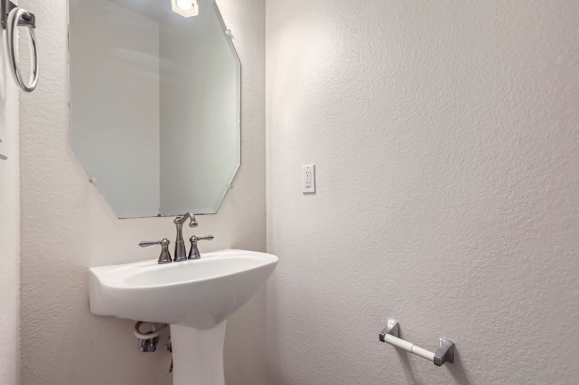 3423 Shiraz Loop Round Rock, TX 78665 - Photo 15 of 28 a bathroom with a sink and mirror