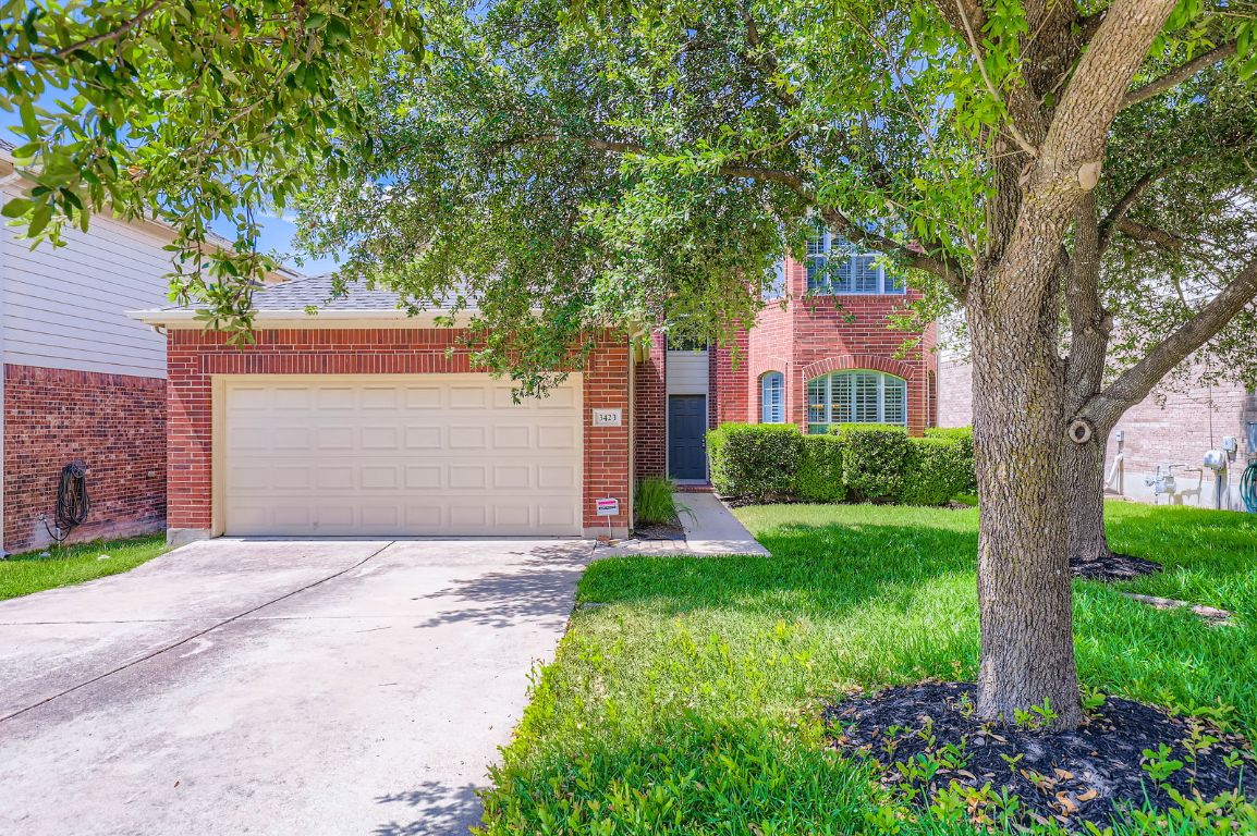 3423 Shiraz Loop Round Rock, TX 78665 - Photo 2 of 28 a front view of a house with a yard and a tree
